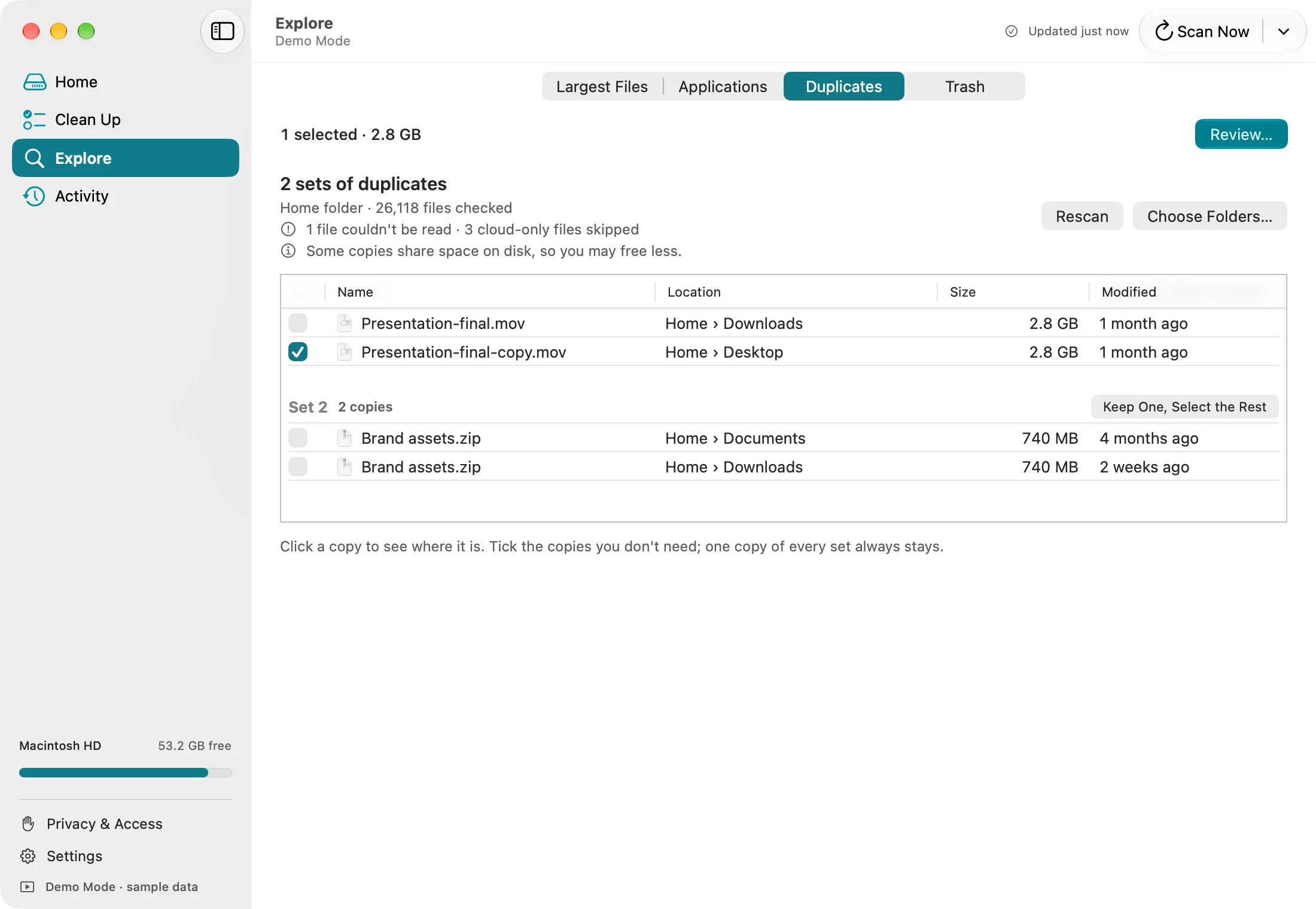 DiskFox's Duplicates list: two sets of exact copies, a 2.8 GB video in Downloads and on the Desktop, and a 740 MB zip file in Documents and Downloads, with a Keep One, Select the Rest button